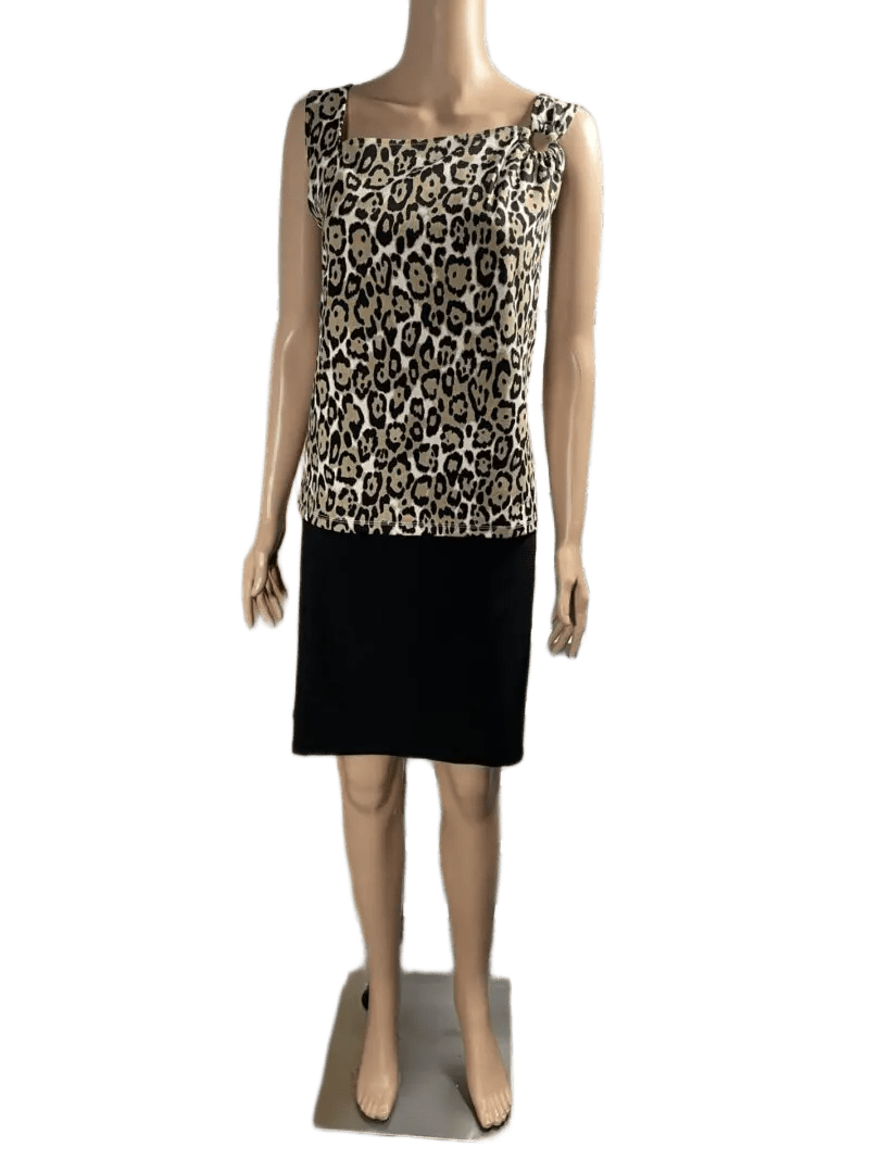 Woman wearing a patterned top and black skirt.