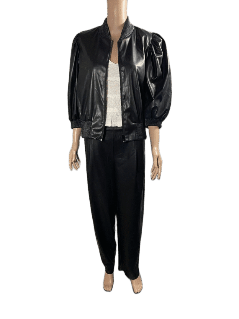 Woman in a stylish black leather jacket and black pants.