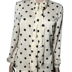 White blouse with black polka dots and buttons.