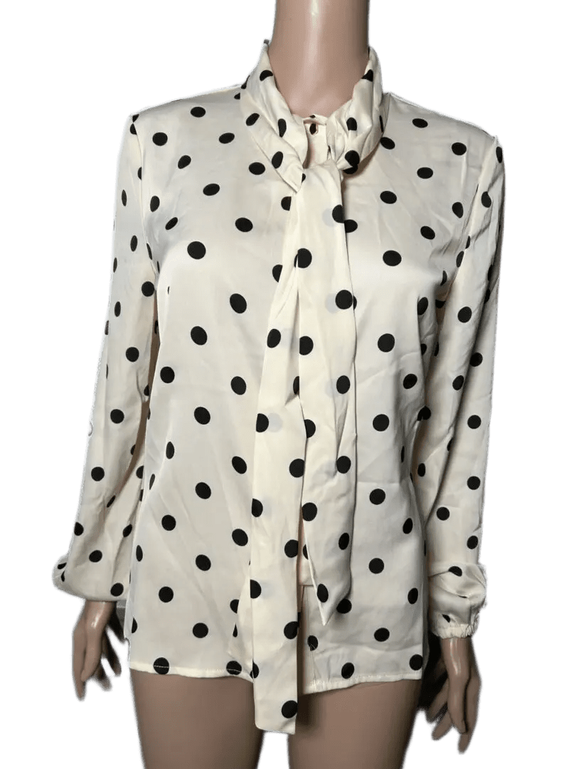 White blouse with black polka dots and buttons.