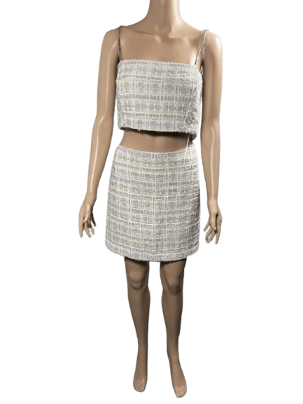 Woman wearing a matching plaid crop top and skirt set.