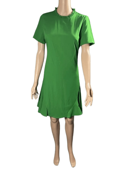 Person wearing a simple green dress.