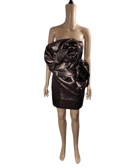 Strapless black dress with shiny, ruched fabric and a large bow detail.