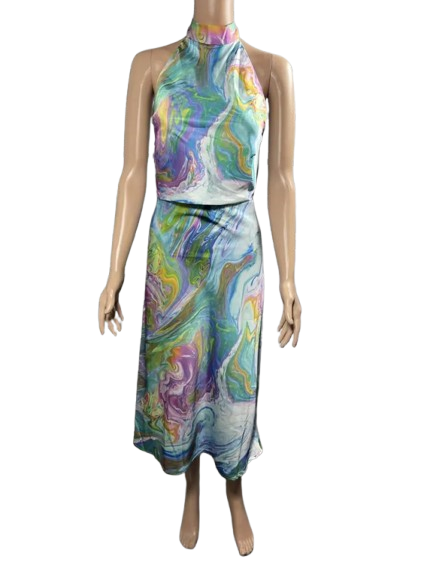 Woman wearing a colorful, sleeveless jumpsuit with abstract patterns.