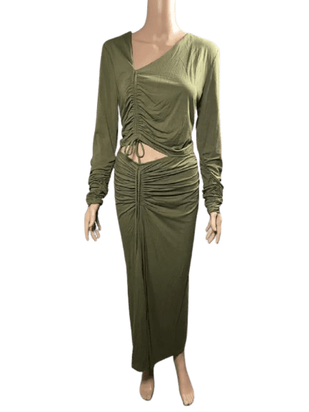 Woman wearing an olive green ruched dress with long sleeves and a midriff cutout.